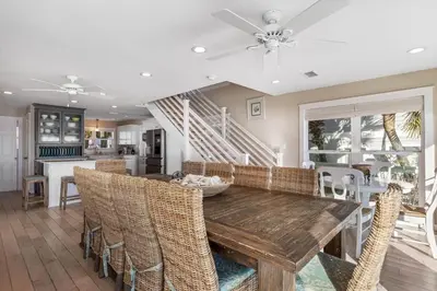 a dining room with a wooden table and chairs at Kokomo in Santa Rosa Beach