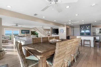 a dining room and living room with a table and chairs at Kokomo in Santa Rosa Beach
