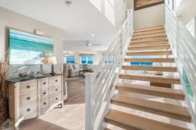 a staircase leading to the living room of a beach house at Kokomo in Santa Rosa Beach