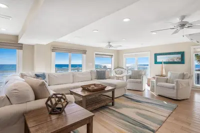 a living room with a couch and a table at Kokomo in Santa Rosa Beach