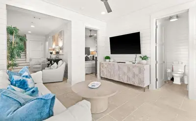 a living room with a couch and a tv at SEAcret to Life in Inlet Beach