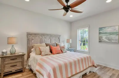 a bedroom with a bed and a ceiling fan at Rosie Disposition in Santa Rosa Beach