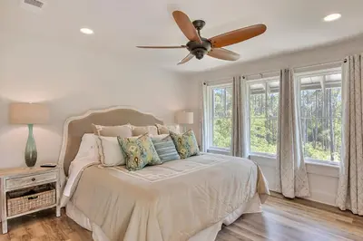 a bedroom with a bed with a ceiling fan at Rosie Disposition in Santa Rosa Beach