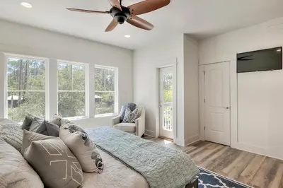 a bedroom with a bed and a ceiling fan at Rosie Disposition in Santa Rosa Beach