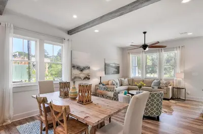 a living room with a table and a couch at Rosie Disposition in Santa Rosa Beach