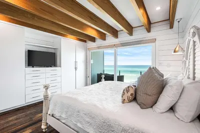 a bedroom with a bed with a view of the ocean at The Good Life in Inlet Beach
