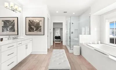 a white bathroom with a tub and a sink at Moonstruck in Santa Rosa Beach