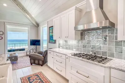 a kitchen with a stove and a view of the ocean at The Sundowner in Panama City Beach