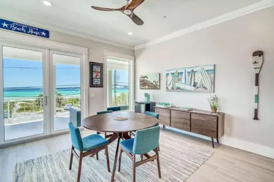 a dining room with a table and chairs at The Sundowner in Panama City Beach