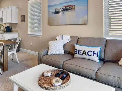 a living room with a couch and a table at Saltwater Dreams in Santa Rosa Beach