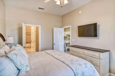 a bedroom with a bed and a flat screen tv at Saltwater Dreams in Santa Rosa Beach