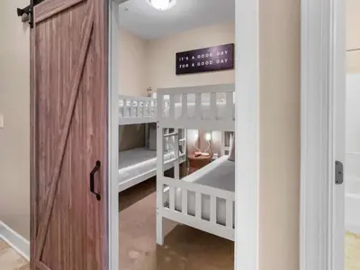 a room with two bunk beds and a door at Saltwater Dreams in Santa Rosa Beach