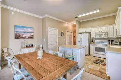 a kitchen and dining room with a wooden table at Saltwater Dreams in Santa Rosa Beach