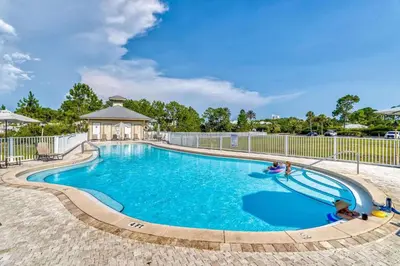 a large swimming pool with a gazebo at Grove Getaway in Santa Rosa Beach