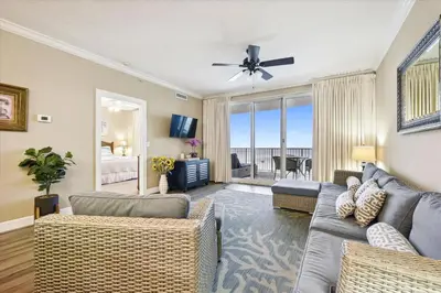 a living room with a couch and a ceiling fan at Twin Palms Resort #1502 by Book That Condo in Panama City Beach