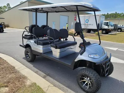 a golf cart parked in a parking lot at Seabourn in Santa Rosa Beach
