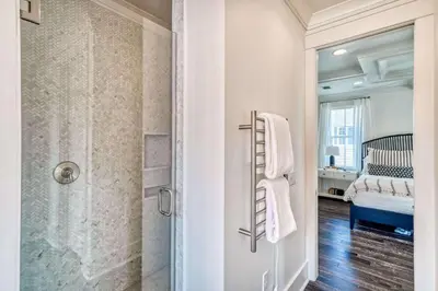 a bathroom with a walk in shower next to a crib at Seabourn in Santa Rosa Beach