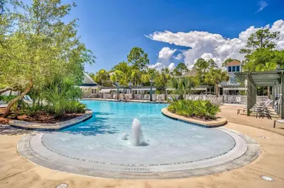 a swimming pool with a fountain in the middle at Seabourn in Santa Rosa Beach