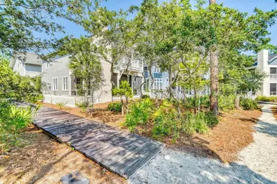 a home with trees and a pathway at Seabourn in Santa Rosa Beach