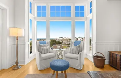 a room with a large window with chairs and a table at Jewel Box at Watersound in Inlet Beach