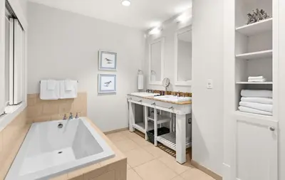a white bathroom with a tub and a sink at Jewel Box at Watersound in Inlet Beach