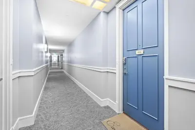 a corridor with a blue door in a hallway at Jewel Box at Watersound in Inlet Beach
