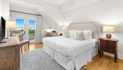 a white bedroom with a bed and a window at Jewel Box at Watersound in Inlet Beach