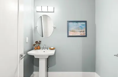 a white bathroom with a sink and a mirror at The Sun Kiss in Santa Rosa Beach