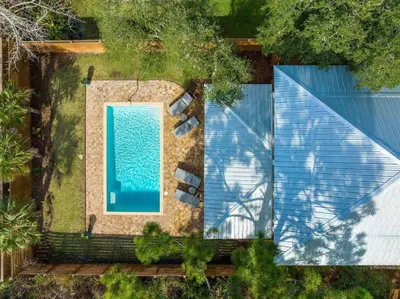 an overhead view of a swimming pool next to a house at The Sun Kiss in Santa Rosa Beach