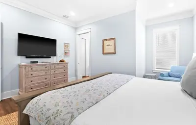 a bedroom with a bed and a flat screen tv at The Sun Kiss in Santa Rosa Beach