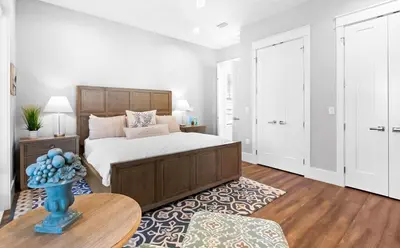 a bedroom with a large bed and a table at The Sun Kiss in Santa Rosa Beach