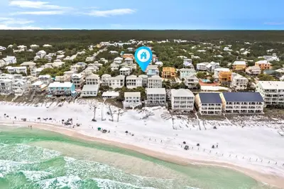 an aerial view of a beach with people on the sand at Blue Heaven in Santa Rosa Beach