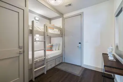 a small bedroom with bunk beds and a closet at Cabanas and Sunsets in Inlet Beach