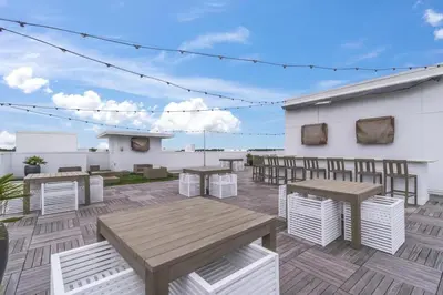 a patio with tables and benches on a building at Cabanas and Sunsets in Inlet Beach
