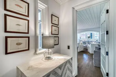 a room with a table with a vase on it at Rosemary Renaissance in Rosemary Beach