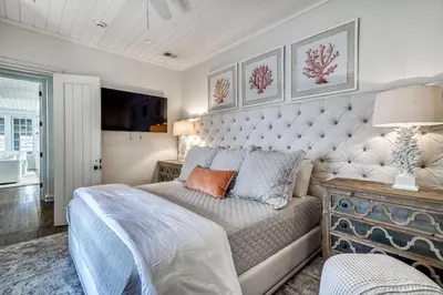 a bedroom with a large bed and a couch at Rosemary Renaissance in Rosemary Beach