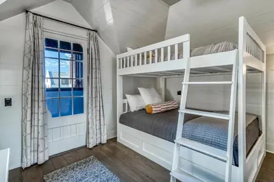 a bedroom with a bunk bed and a ladder at Rosemary Renaissance in Rosemary Beach