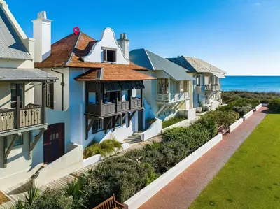 a row of houses with the ocean in the background at Rosemary Renaissance in Rosemary Beach