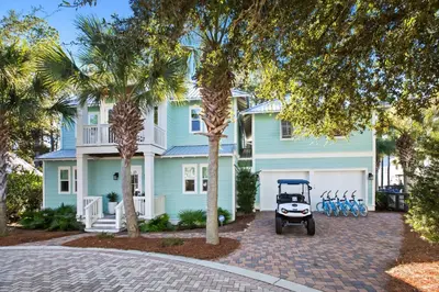 a golf cart parked in front of a house at Family Tides in Santa Rosa Beach