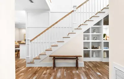 a staircase in a house with a bench under it at Family Tides in Santa Rosa Beach