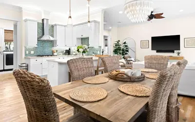 a kitchen and dining room with a wooden table and chairs at Family Tides in Santa Rosa Beach