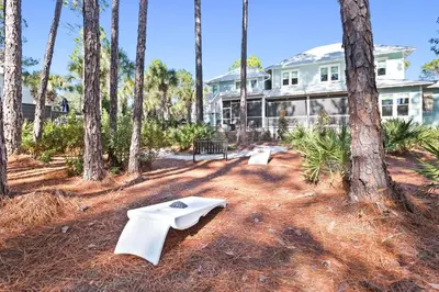 a building with palm trees in front of it at Family Tides in Santa Rosa Beach