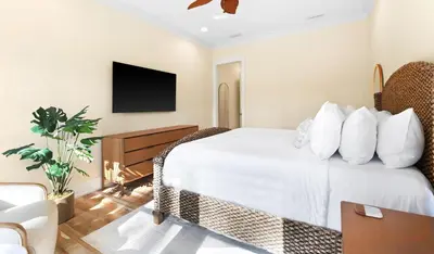 a hotel room with a bed and a tv at Family Tides in Santa Rosa Beach
