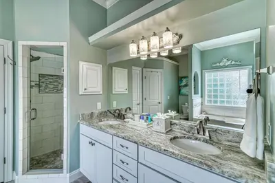 a bathroom with two sinks and a shower at Sandy's Seacrest in Inlet Beach