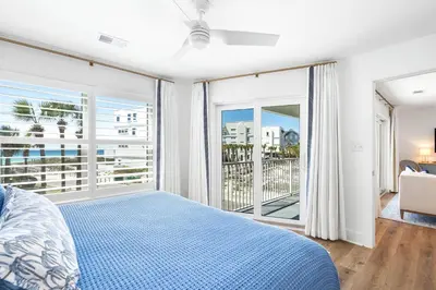 a bedroom with a bed and a balcony at After Dune Delight in Santa Rosa Beach