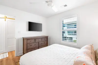 a white bedroom with a bed and a window at After Dune Delight in Santa Rosa Beach