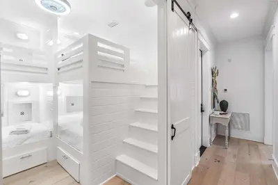 a bedroom with white walls and a white closet at Sunshine and Fresh Air in Inlet Beach
