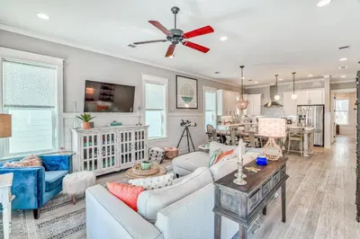 a living room with a couch and a ceiling fan at Daydream Believer (Seagrove) in Santa Rosa Beach