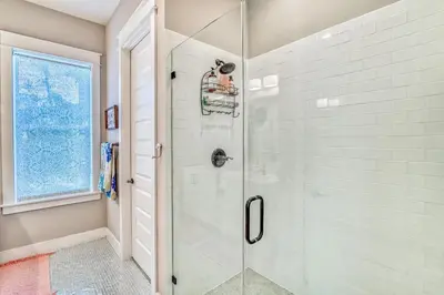 a bathroom with a shower with a glass door at Daydream Believer (Seagrove) in Santa Rosa Beach