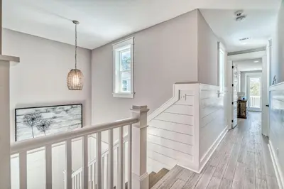 a white staircase in a home with white walls at Daydream Believer (Seagrove) in Santa Rosa Beach